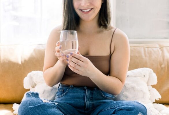 Lady in New Hampshire holding a glass of water inside a house