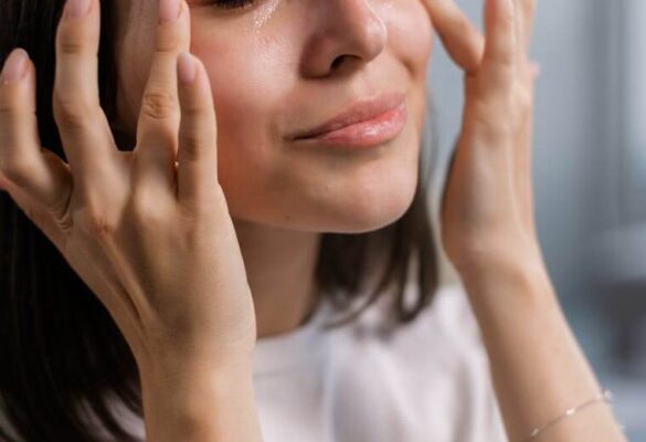 Woman touches the soft, healthy skin on her face thanks to clean, filtered water at home.