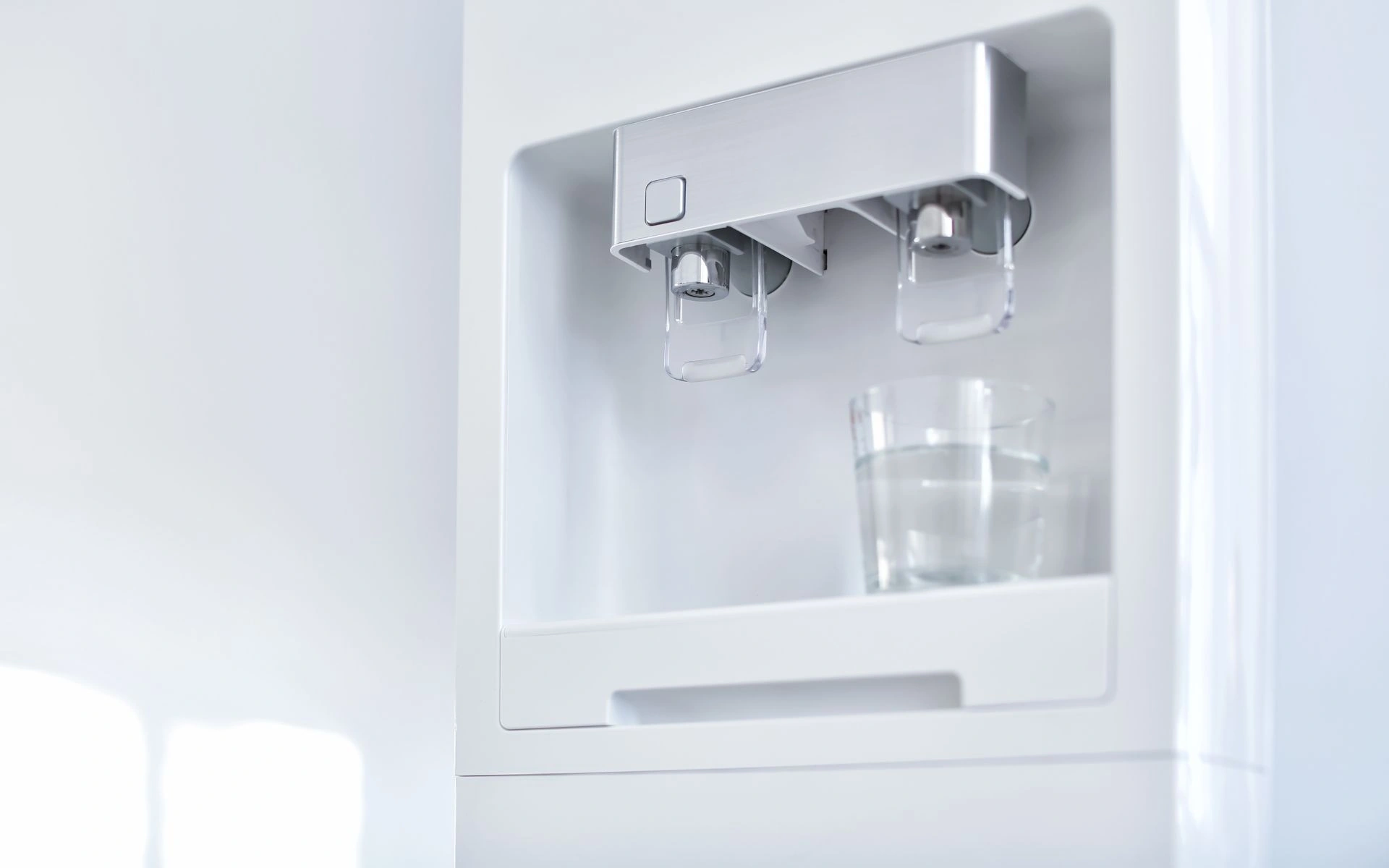 water dispensing from a refrigerator into a glass