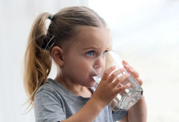 Girl drinking water from a glass