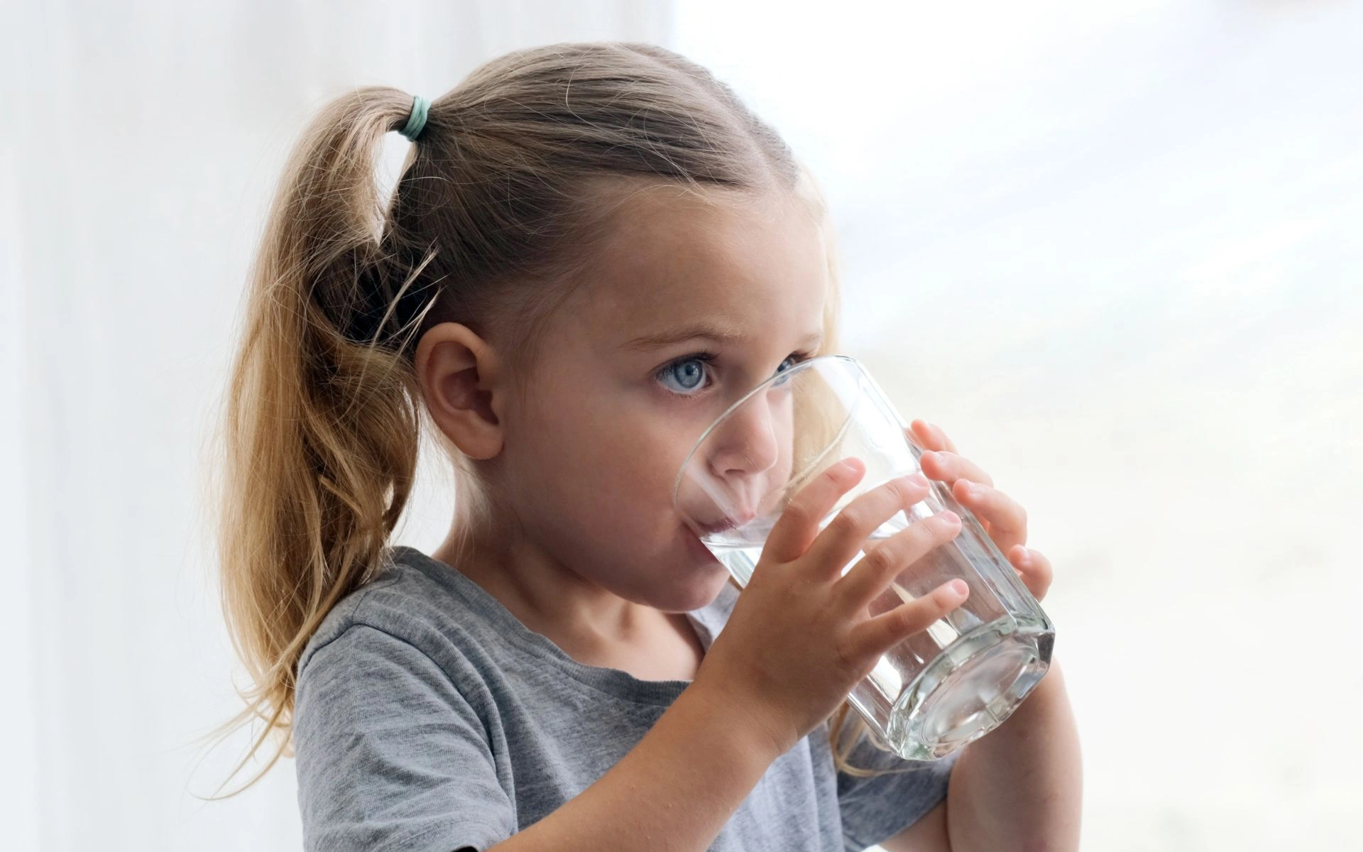 Girl drinking water from a glass