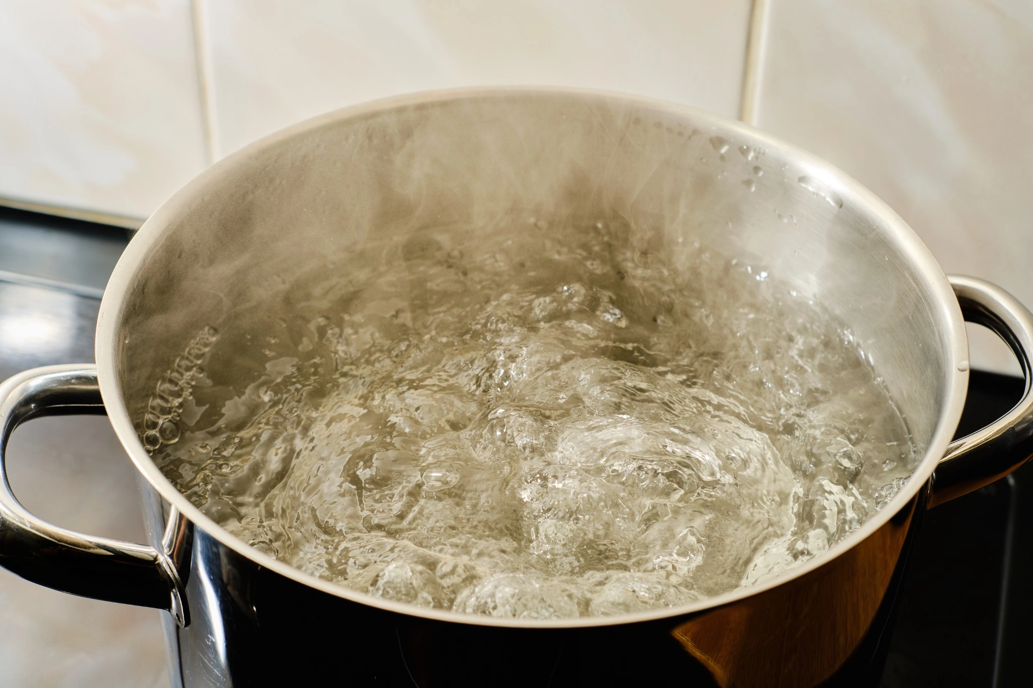 Pot of boiling water on a stove used to illustrate the myth that boiling water removes all contaminants