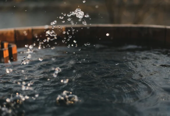 Well water surface with splashing droplets representing private well water testing in New Hampshire