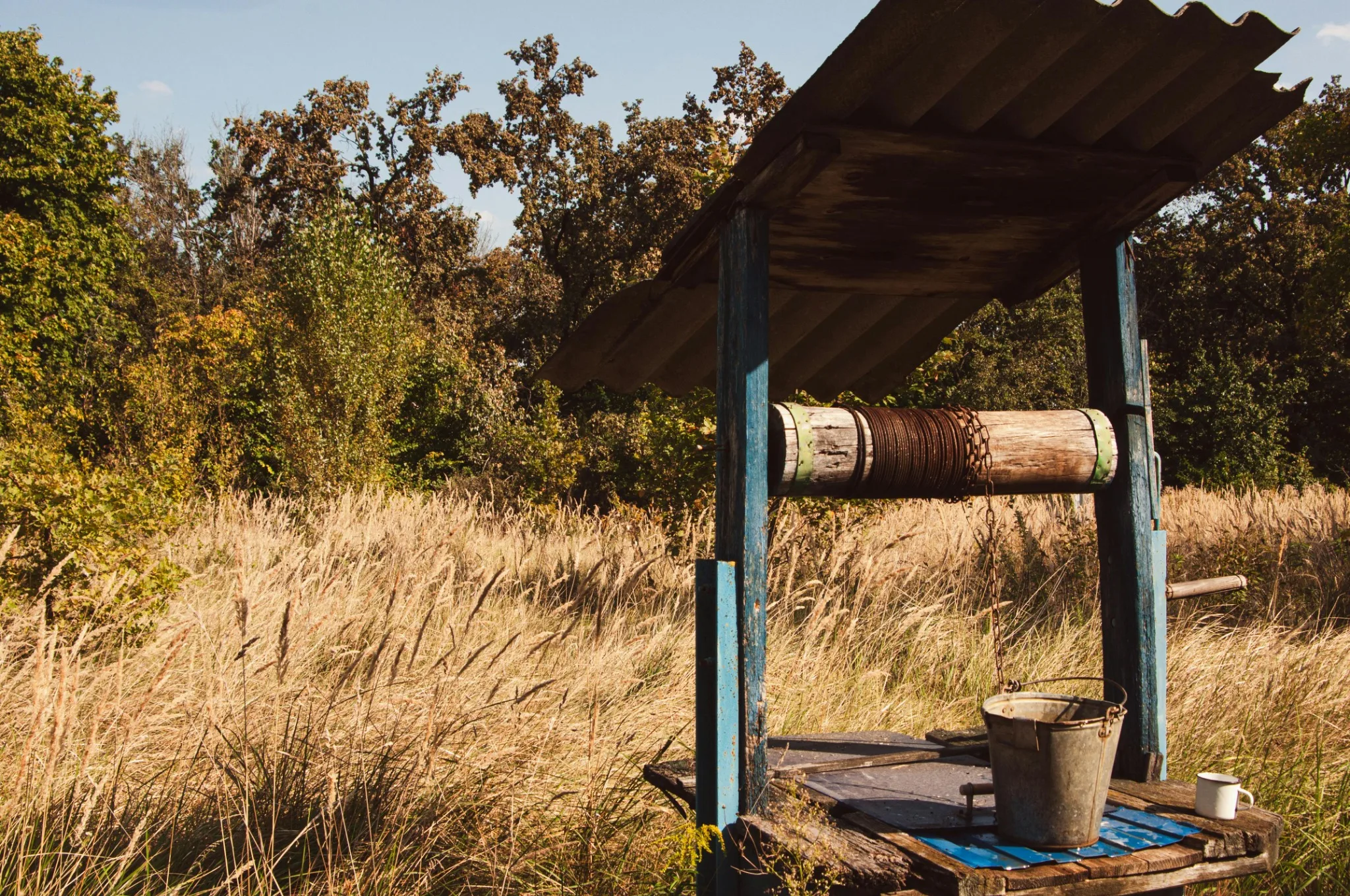 Old private well in a rural field representing well water testing for New Hampshire homes